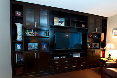 Photo of a large contemporary open concept family room in Edmonton with beige walls and a built-in media wall.