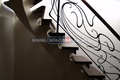 Bespoke curved staircase, wrought iron balustrade