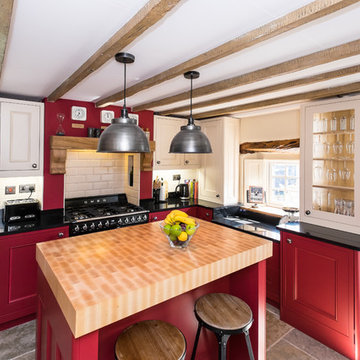 Striking red traditional kitchen in  Georgian cottage