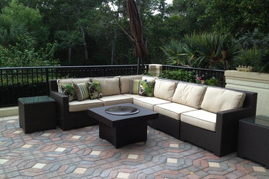 Inspiration for a large contemporary backyard patio in Orlando with a fire feature, natural stone pavers and no cover.