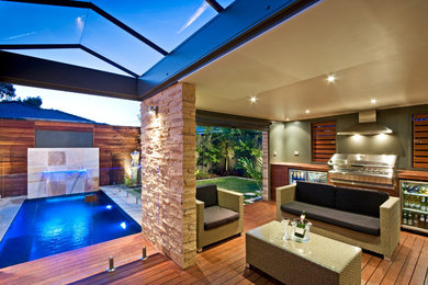 Inspiration for a mid-sized backyard rectangular lap pool in Melbourne with a water feature.