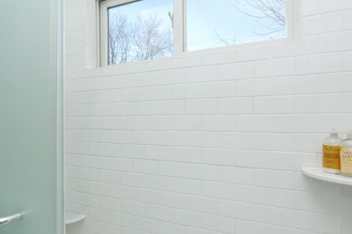 Mid-sized white tile and subway tile ceramic tile, white floor and single-sink bathroom photo in New York with white cabinets, a two-piece toilet, blue walls, quartz countertops, white countertops and a built-in vanity
