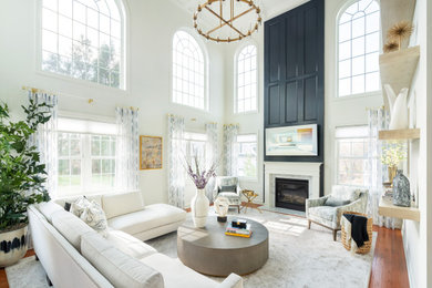 Transitional enclosed medium tone wood floor and brown floor family room photo in Philadelphia with white walls and a wall-mounted tv