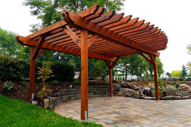 Inspiration for a timeless concrete paver patio remodel in Denver with a pergola
