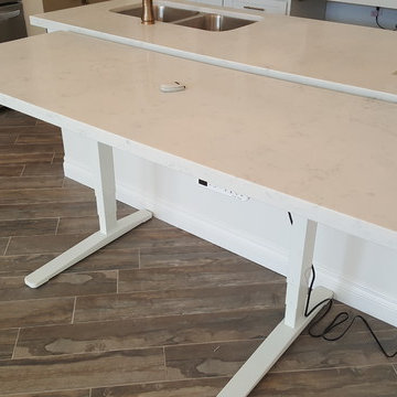 Electric, adjustable height table provides easy access for baking and task work