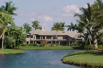 Example of a large gray two-story wood exterior home design in Miami