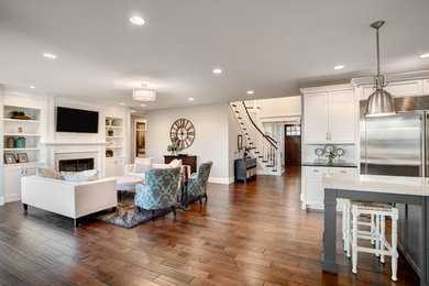 Example of a large minimalist formal and open concept dark wood floor and brown floor living room design in Los Angeles with gray walls, a standard fireplace, a tile fireplace and a wall-mounted tv
