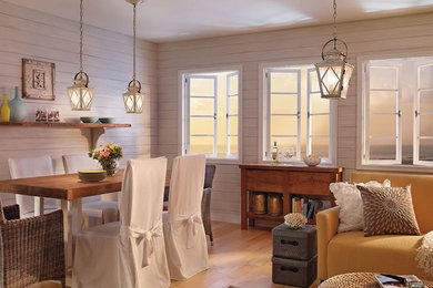 Example of a mid-sized beach style light wood floor great room design in Other with white walls and no fireplace
