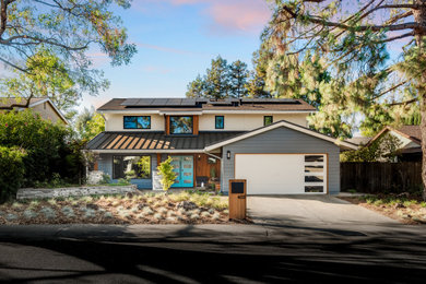 Example of a large trendy blue two-story wood exterior home design in Sacramento with a metal roof and a gray roof