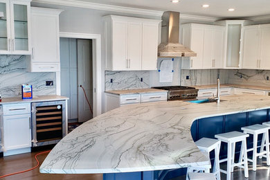 Kitchen - large coastal kitchen idea in Baltimore with white cabinets, quartzite countertops, stone slab backsplash and an island