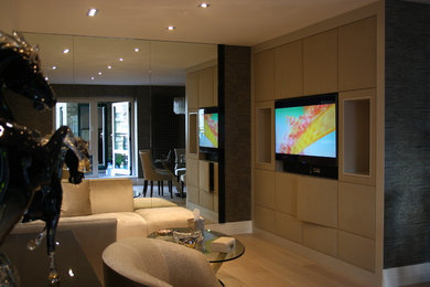 Photo of a large contemporary enclosed living room in London with a reading nook, beige walls and a built-in media unit.