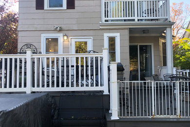 Example of a mid-sized classic backyard deck design in Newark with no cover