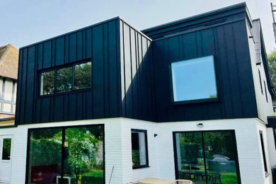 Design ideas for a large and black traditional two floor detached house in Sussex with mixed cladding and a black roof.