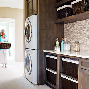 Inspiration for a medium sized contemporary single-wall utility room in Other with a submerged sink, raised-panel cabinets, grey cabinets, engineered stone countertops, carpet, a stacked washer and dryer and brown walls.