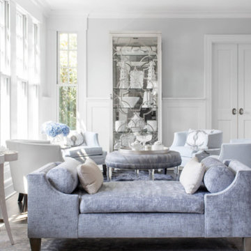Elegant Living Room with Blue Velvet Chaise and Mirrored Display Cabinet