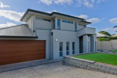 Expansive contemporary two-storey concrete beige exterior in Adelaide.