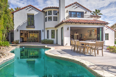 Tuscan white two-story stucco exterior home photo in San Francisco with a tile roof