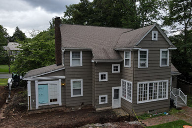 Large two-story concrete fiberboard exterior home photo in New York