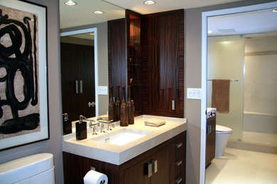 Design ideas for a mid-sized contemporary master bathroom in New York with flat-panel cabinets, dark wood cabinets, an alcove shower, a two-piece toilet, white tile, porcelain tile, beige walls, porcelain floors, an undermount sink and engineered quartz benchtops.
