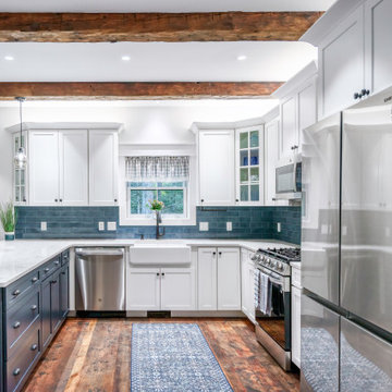 Bright and Airy Kitchen: Linen Cabinets with Blue Backsplash and Rustic Beams