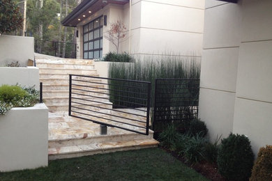 This is an example of a mid-sized contemporary partial sun backyard stone outdoor basketball/tennis/multi-game court in San Francisco.