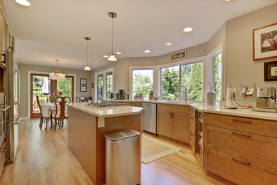Open concept kitchen - mid-sized contemporary galley light wood floor open concept kitchen idea in Seattle with an undermount sink, shaker cabinets, medium tone wood cabinets, quartz countertops, stainless steel appliances and an island