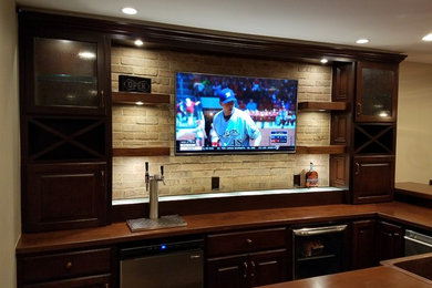 Inspiration for a transitional porcelain tile basement remodel in Columbus with beige walls, a standard fireplace and a stone fireplace