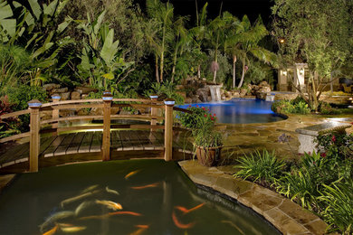 This is an example of an expansive mediterranean backyard custom-shaped pool in Orange County.