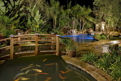 Huge tuscan backyard custom-shaped pool photo in Orange County