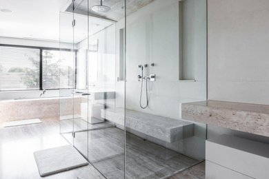 Example of a large minimalist master gray tile and porcelain tile porcelain tile, gray floor and vaulted ceiling bathroom design in Phoenix with white cabinets, a wall-mount toilet, gray walls, a vessel sink and a hinged shower door