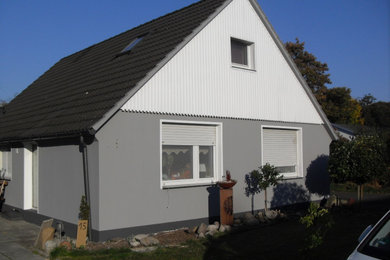 Mittelgroßes Einfamilienhaus mit Putzfassade und grauer Fassadenfarbe in Bremen
