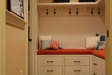 Inspiration for a mid-sized timeless ceramic tile and brown floor mudroom remodel in New York with beige walls