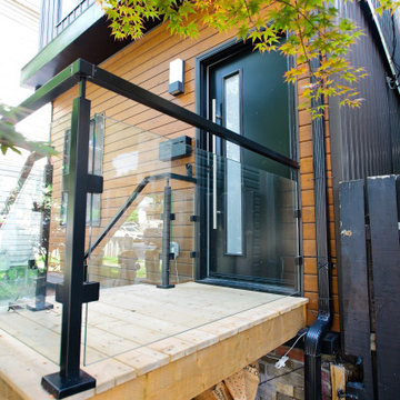 Compact Wood Entry Deck with Black Aluminum and Glass Railing | East York