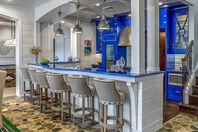 Eat-in kitchen - mid-sized transitional l-shaped slate floor and gray floor eat-in kitchen idea in Detroit with a farmhouse sink, recessed-panel cabinets, blue cabinets, wood countertops, white backsplash, stainless steel appliances and a peninsula