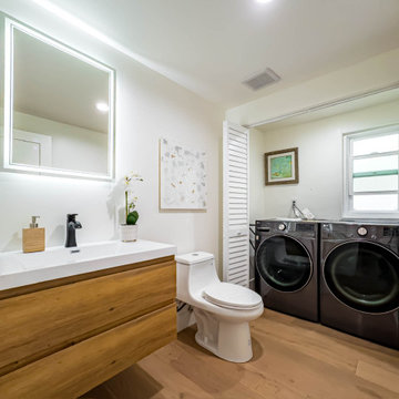Bathroom with Concealed Stacked Laundry Behind Louvered Doors