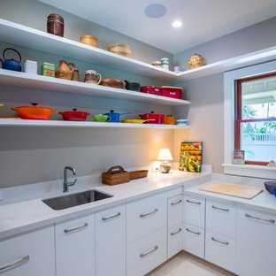 Mid-sized transitional kitchen pantry photos - Mid-sized transitional l-shaped travertine floor and beige floor kitchen pantry photo in Hawaii with flat-panel cabinets, white cabinets, quartz countertops and white backsplash