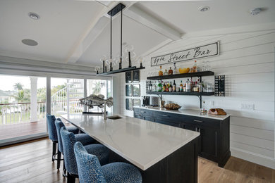 Example of a beach style home bar design in Tampa
