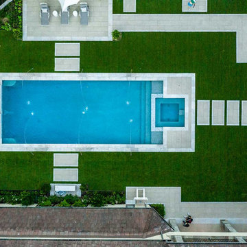 Rectangular pool, covered patio and kitchen, outdoor shower, landscaping