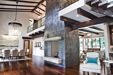 Great room - large transitional medium tone wood floor and brown floor great room idea in Boise with white walls and a two-sided fireplace