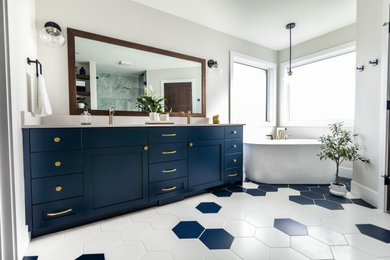 Example of a large transitional master porcelain tile, multicolored floor and double-sink bathroom design in Calgary with blue cabinets, white walls, an undermount sink, quartz countertops, a hinged shower door, white countertops and a built-in vanity