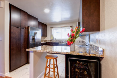 Small modern u-shaped separate kitchen in Hawaii with a single-bowl sink, flat-panel cabinets, dark wood cabinets, granite benchtops, stainless steel appliances, ceramic floors, no island, beige floor and yellow benchtop.