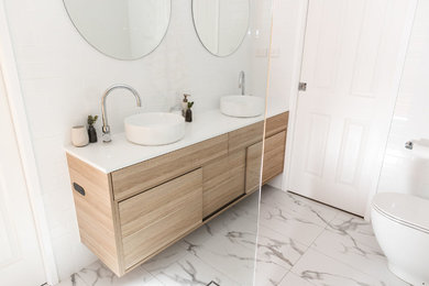 Mid-sized contemporary master wet room bathroom in Canberra - Queanbeyan with light wood cabinets, white tile, subway tile, white walls, porcelain floors, a vessel sink, engineered quartz benchtops, white floor, an open shower and white benchtops.