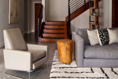 Inspiration for a contemporary open concept concrete floor living room remodel in Denver with gray walls