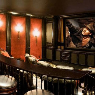 Classic enclosed home cinema in Oklahoma City with orange walls, carpet and a built-in media unit.