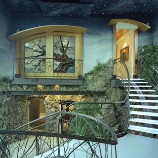 Design ideas for a large contemporary glass spiral staircase in Denver with metal risers.