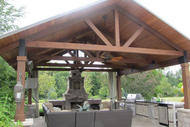 Inspiration for a mid-sized timeless backyard concrete paver patio remodel in Chicago with a gazebo