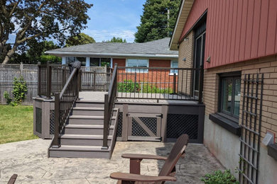 Example of a mid-sized minimalist backyard metal railing deck skirting design in Ottawa