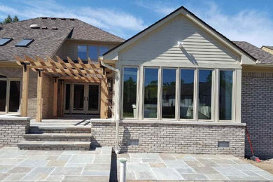 Mid-sized transitional gray two-story mixed siding house exterior idea in Detroit with a hip roof and a shingle roof