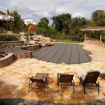 Lowhill Township custom pool with sunshelf, slide, waterfall, & raised spa