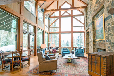 Living room - rustic open concept medium tone wood floor, brown floor, exposed beam, vaulted ceiling and wood ceiling living room idea in Denver with a standard fireplace and a stone fireplace